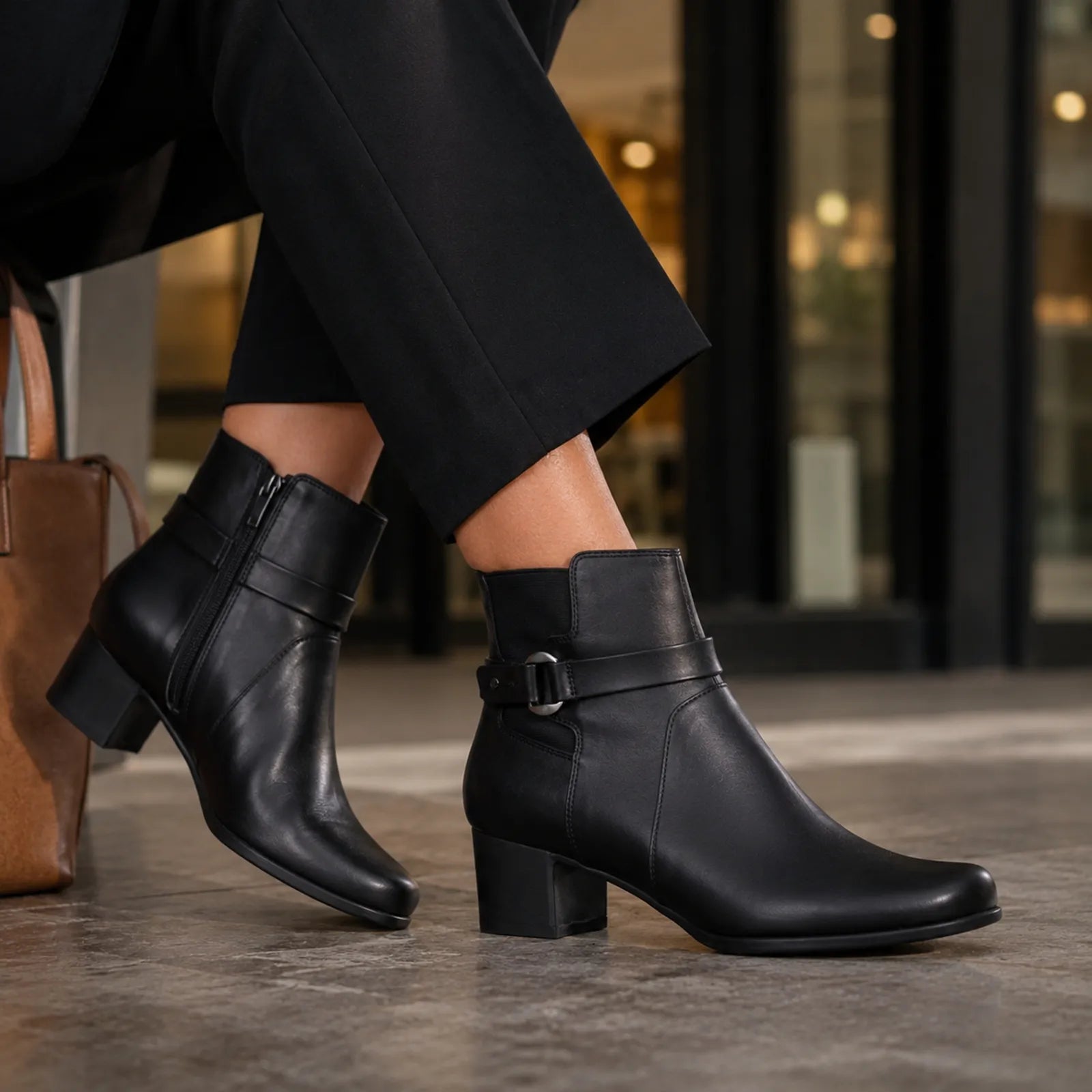 Black leather mid-ankle boots with side buckle detail and chunky block heel