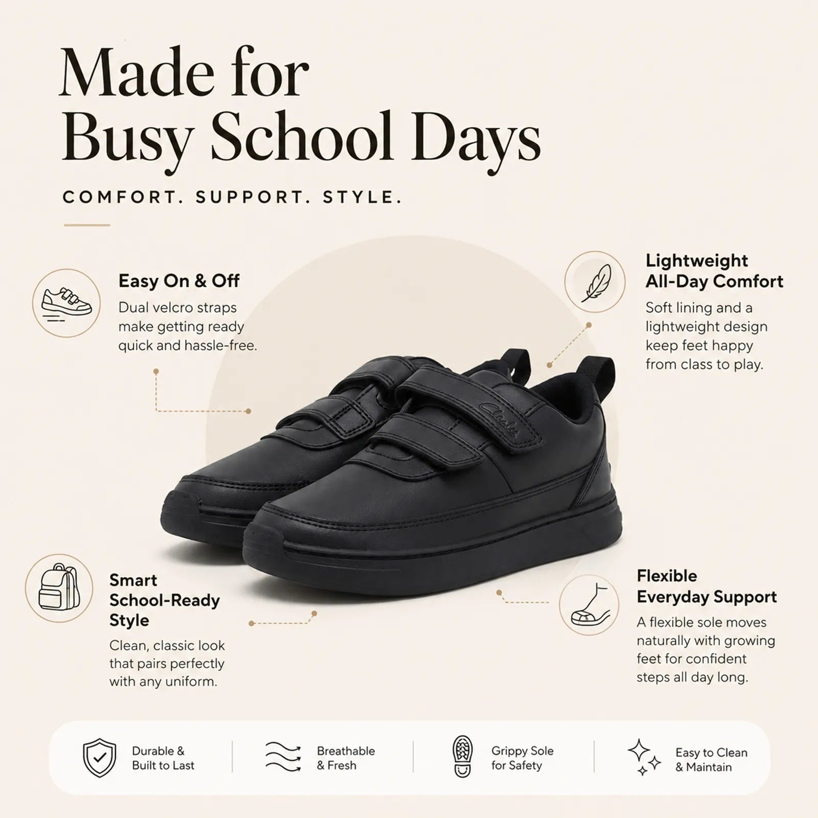 Black kids sneakers with dual Velcro straps and flexible rubber sole, pull tab