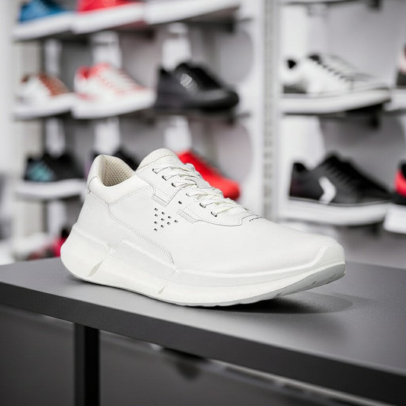 White men's lace-up sneakers displayed on a store shelf