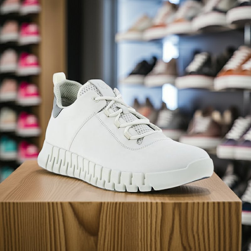 Men's white lace-up sneakers on a wooden display
