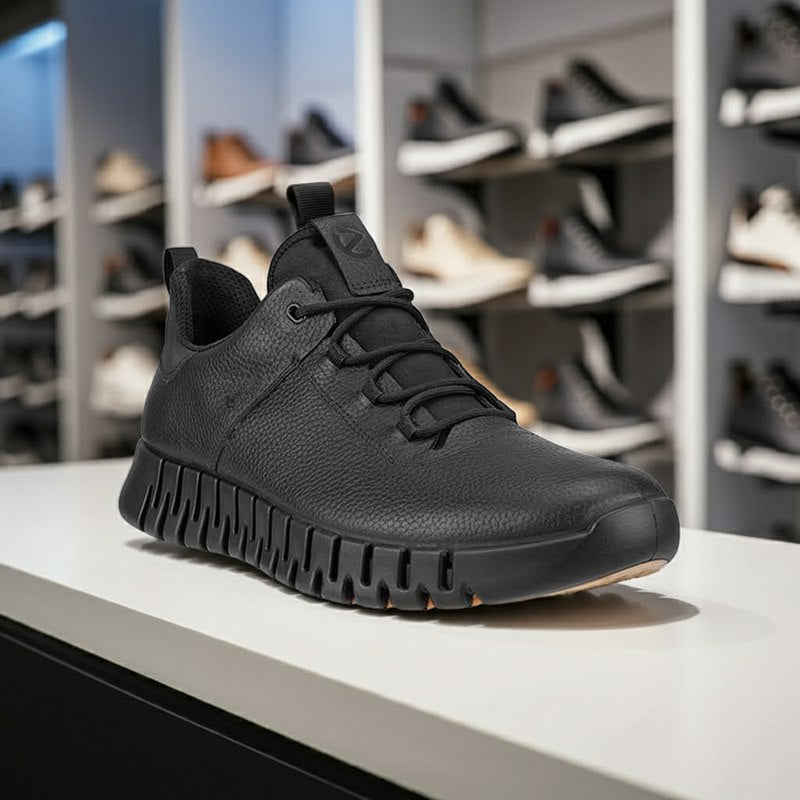 Men's black lace-up sneakers on a display platform