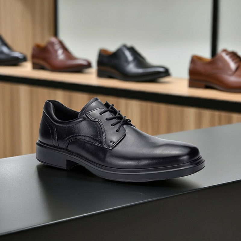 Black leather lace-up derby dress shoe on display, side profile.