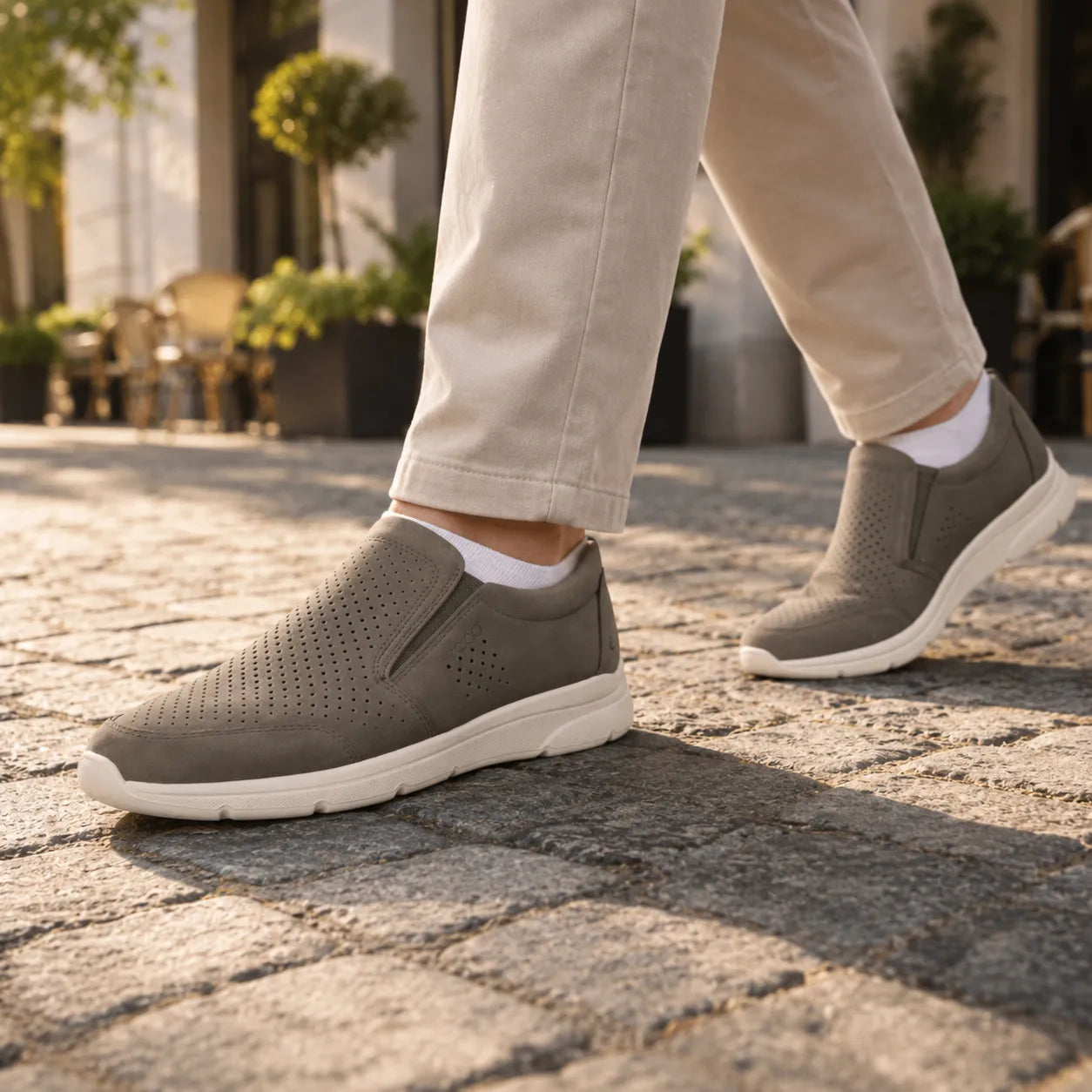Men's slip-on low shoes in dark green nubuck with perforated panels and elastic goring