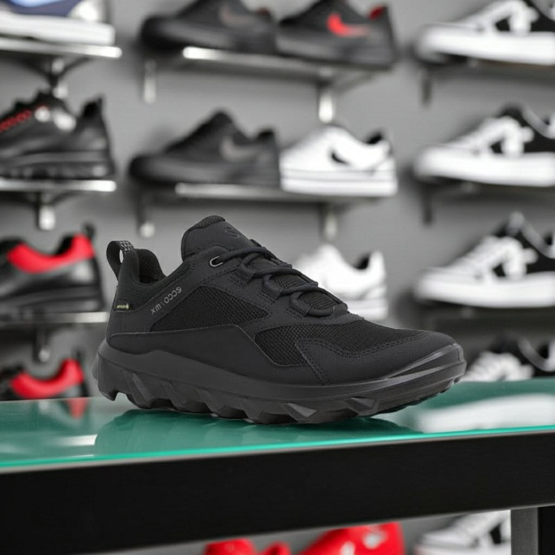 Black lace-up athletic sneakers with mesh upper and chunky treaded outsole