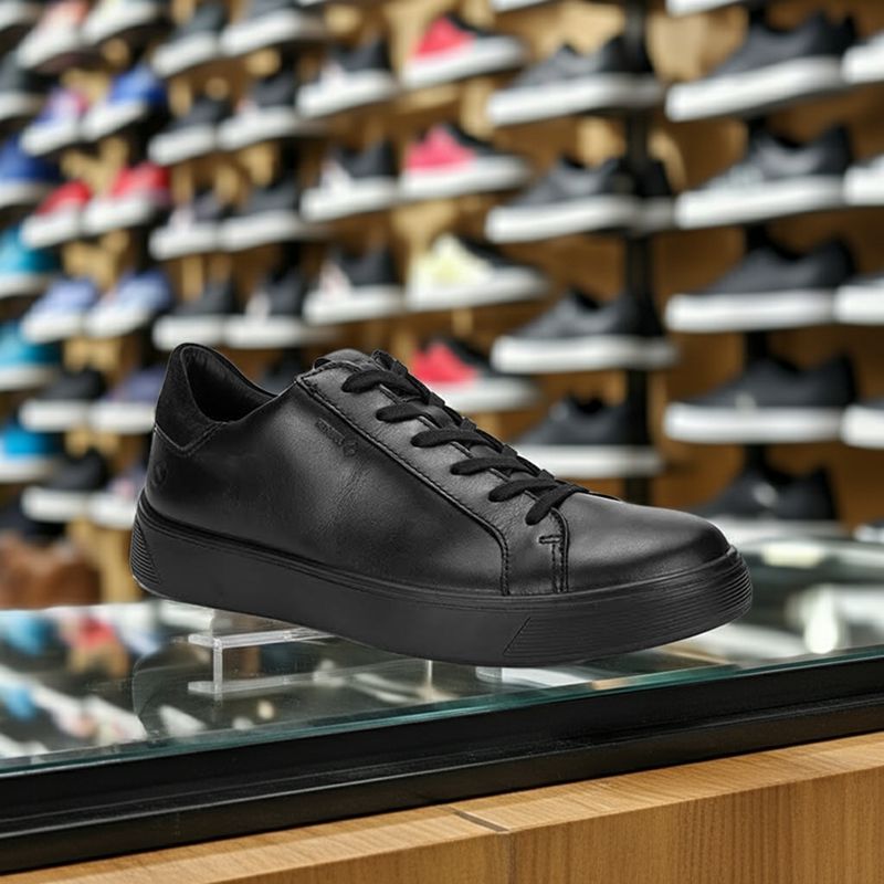 Black leather lace-up sneaker on display with low rubber sole