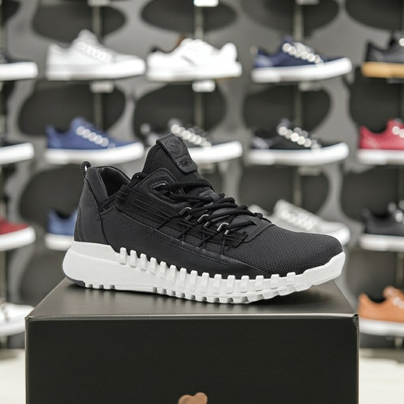Men's black zip-top sneakers on a box, lace-up front and white textured outsole