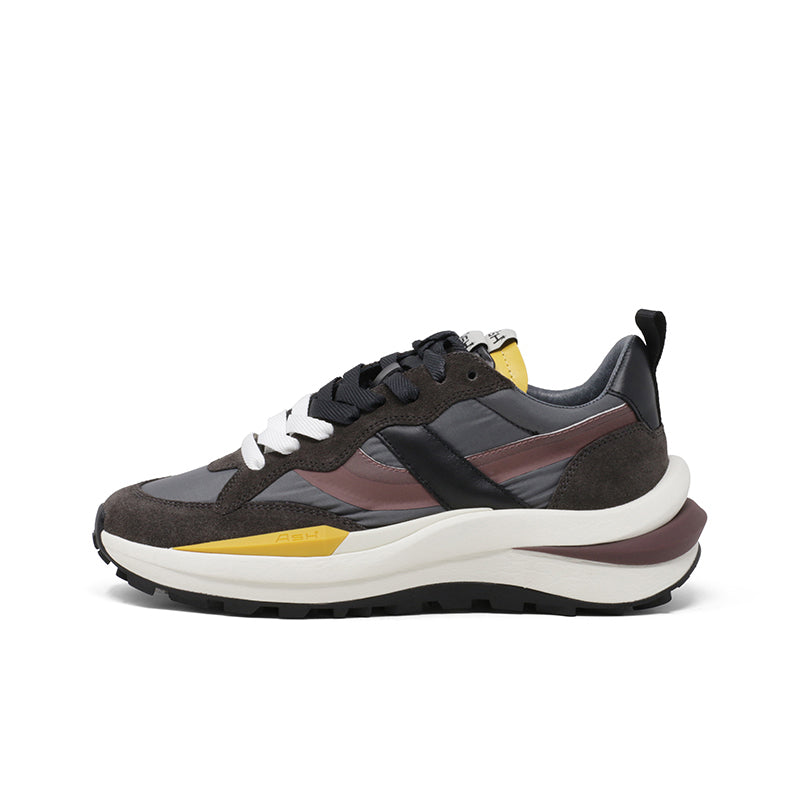 Women trainers side view in dark brown and burgundy panels, black laces, thick white sole