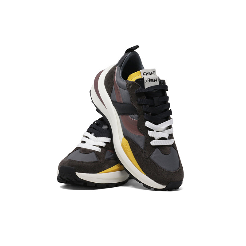 Women trainers angled view in dark brown with burgundy stripe, white lace accents, chunky sole
