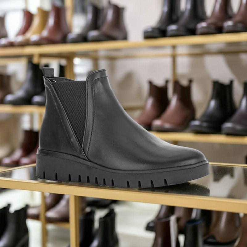 Black leather chelsea boot with elastic gore and thick lugged sole