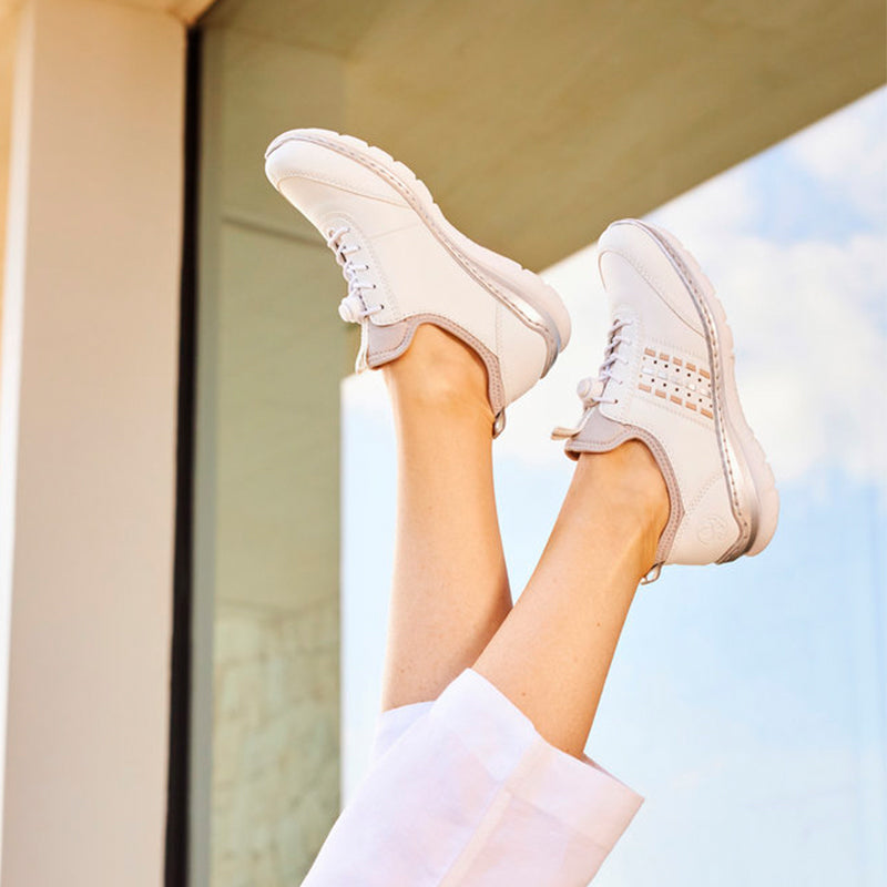 Womens white low-top sneakers with lace-up front and padded collar