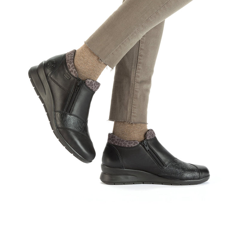 Black ankle boots with side zip and leopard-print sock-like cuffs