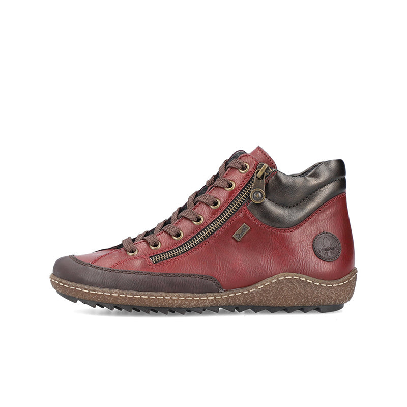 Red ankle boot with lace-up front, side zipper, and rugged outsole.
