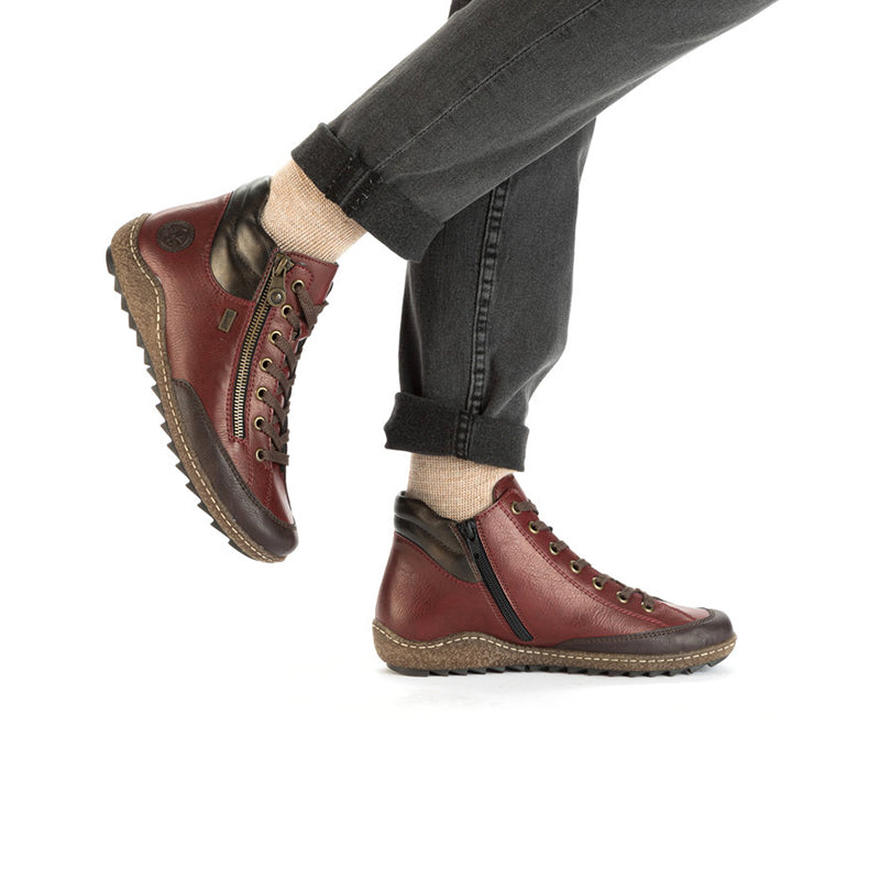 Red lace-up ankle boots with dark side accents and thick rubber sole.