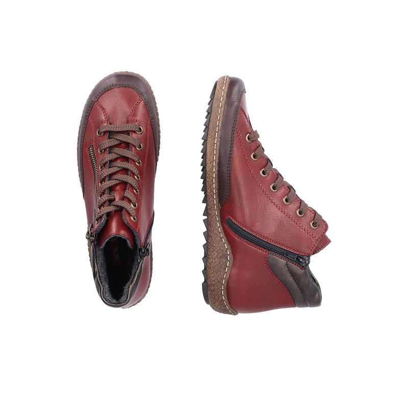 Red lace-up ankle boot with dark trim and rubber outsole; interior lining visible.