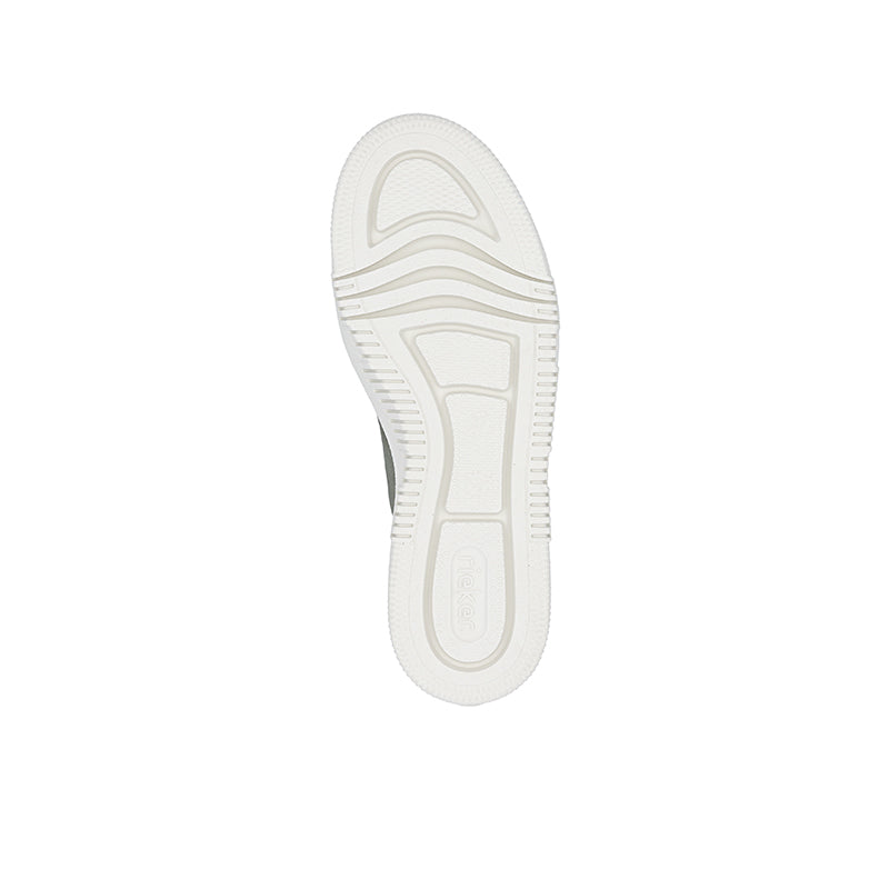 White outsole of green sneaker with textured tread pattern