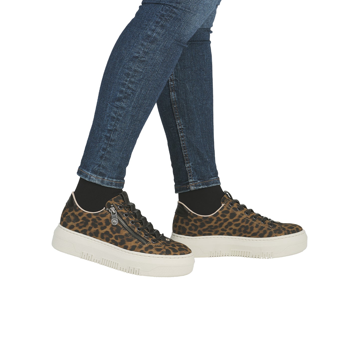 Leopard-print low-top sneakers on legs with light outsole and lace-up front