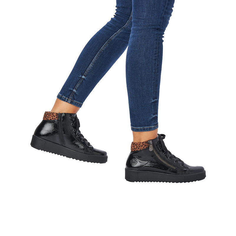 Black lace-up ankle boots with leopard print collar panel and chunky tread sole