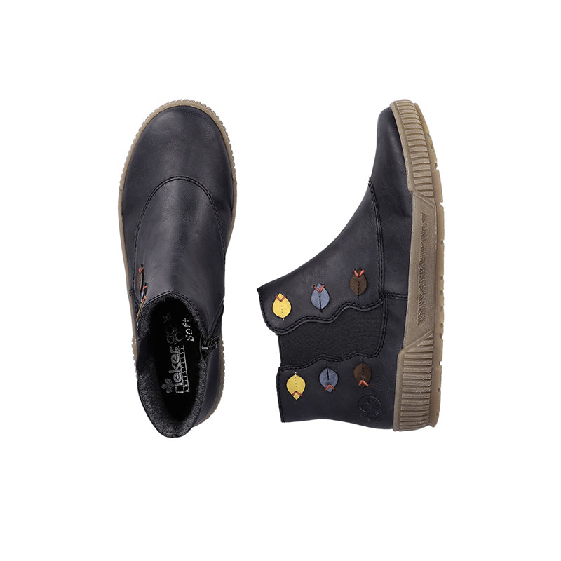 Women’s dark blue ankle boots, side view, with colorful patch accents and tan sole