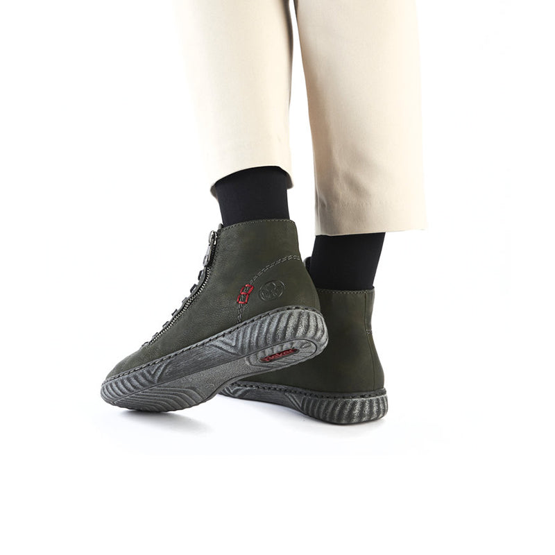 Olive green ankle boots with lace-up front and rugged textured rubber sole