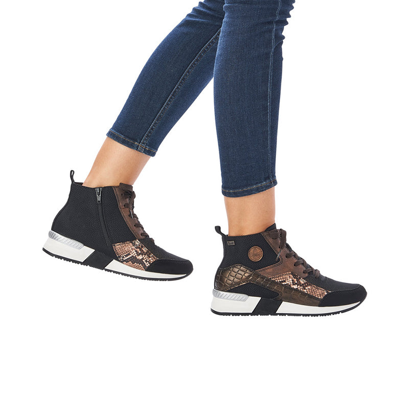 Women's ankle boots with laced front and side zip, worn with blue jeans