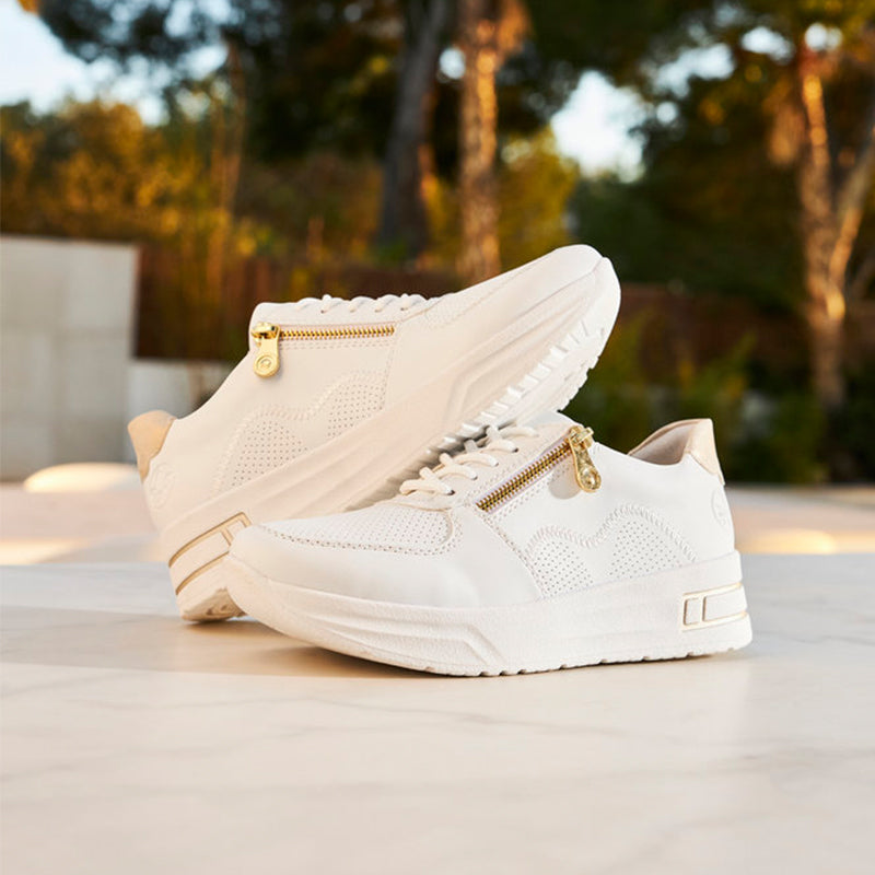 White high-top sneaker with gold zipper, lace-up closure, padded collar