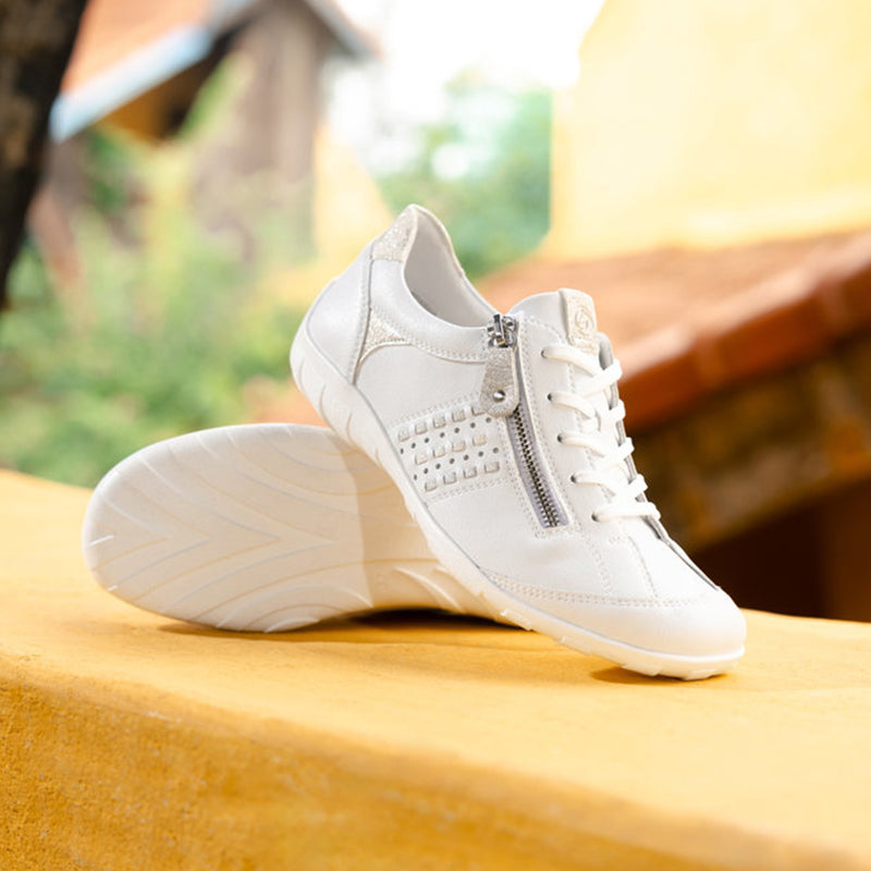 White leather sneaker with side zipper, lace-up front, and cushioned sole