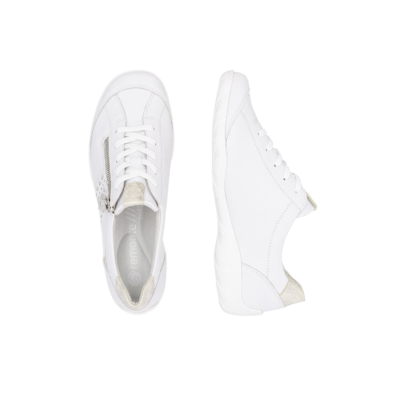 White leather sneaker showing laces, padded collar, and insole
