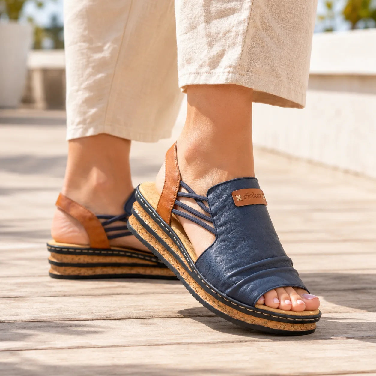 Rieker women flatform sandals navy tan man made elastic strap 62962-14 on foot view with outfit