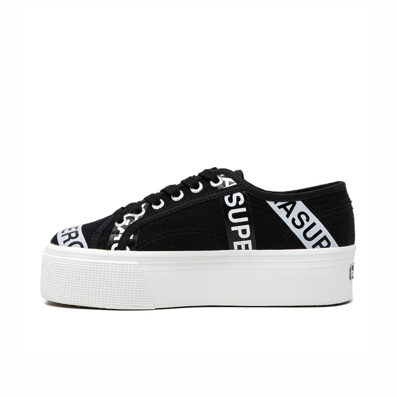 Black canvas platform sneakers with lace-up front and branded side lettering tape detail