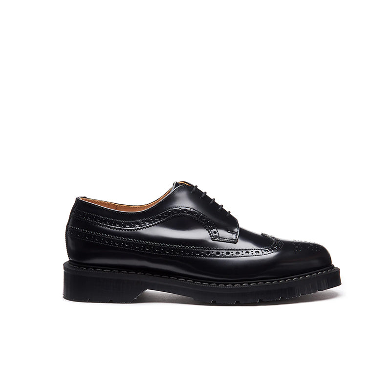 Black leather oxford-style shoes with brogue detailing and thick sole