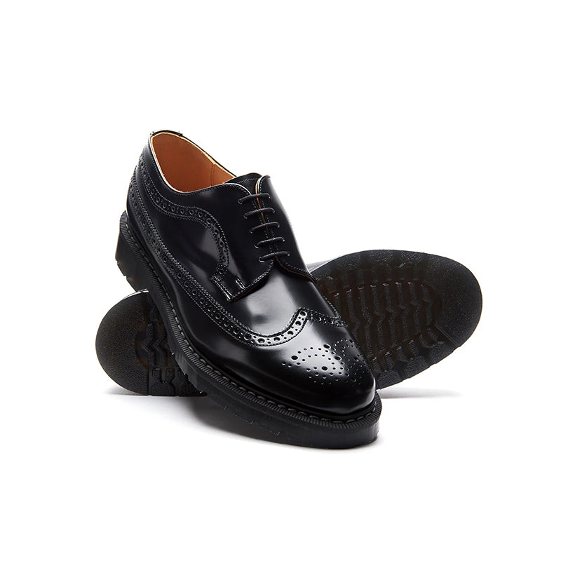 Black leather brogue lace-up shoes with perforated toe and treaded sole edge