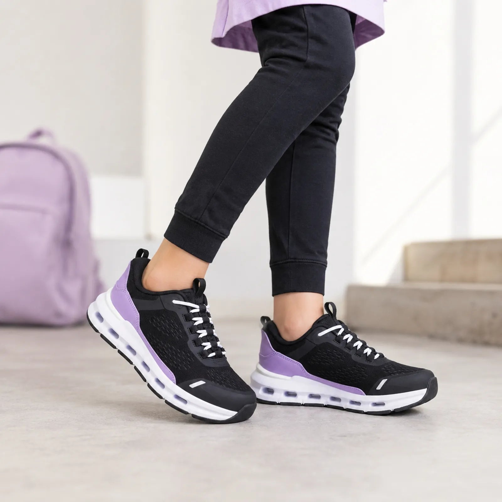 Girls' lace-up sneakers in black with purple stripes and white cushioning sole