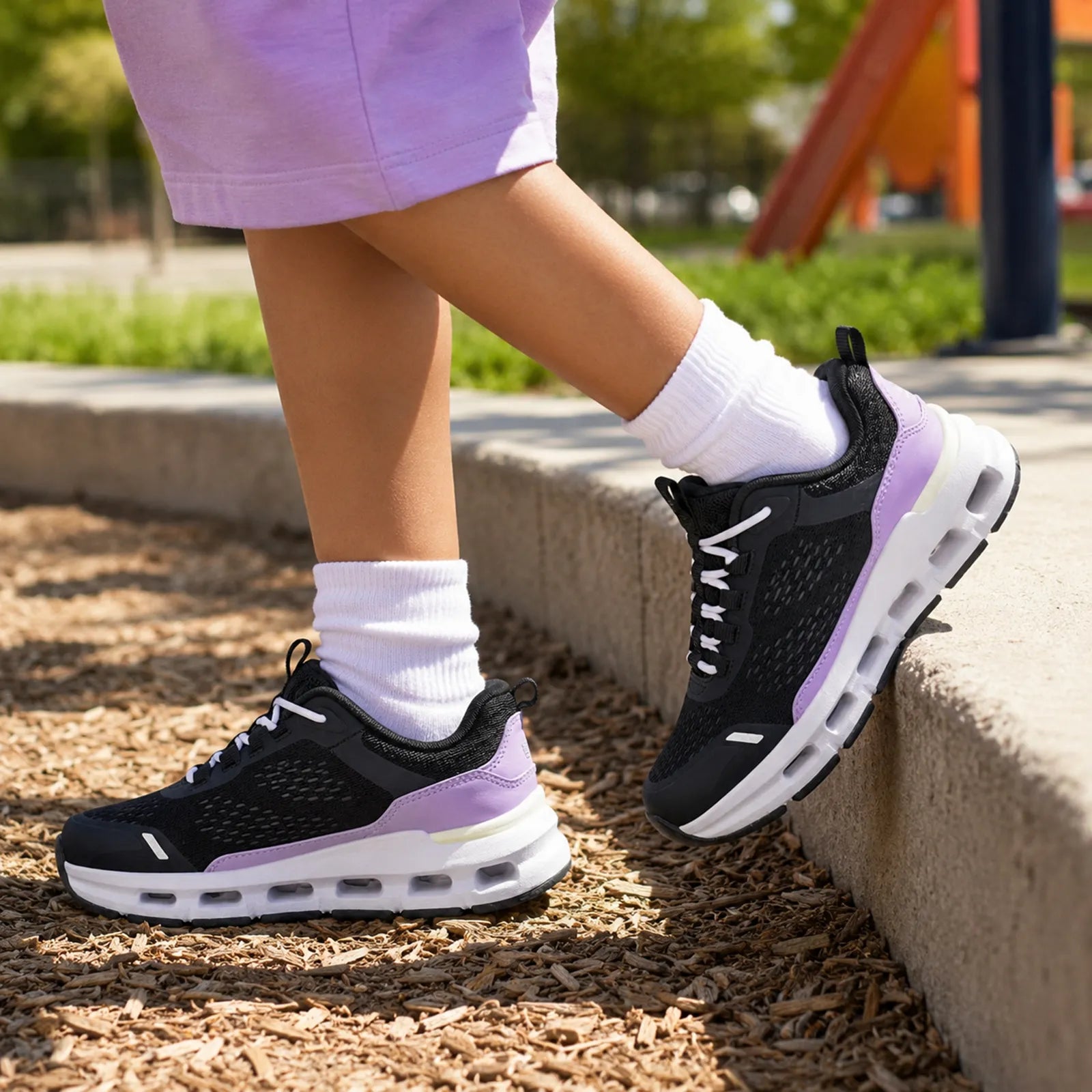 Girls' lace-up sneakers in black with purple accents and cushioned white sole