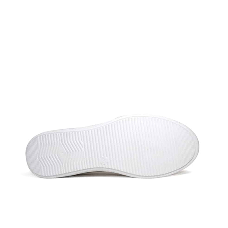 White outsole view of brown leather slip-on sneakers with textured tread