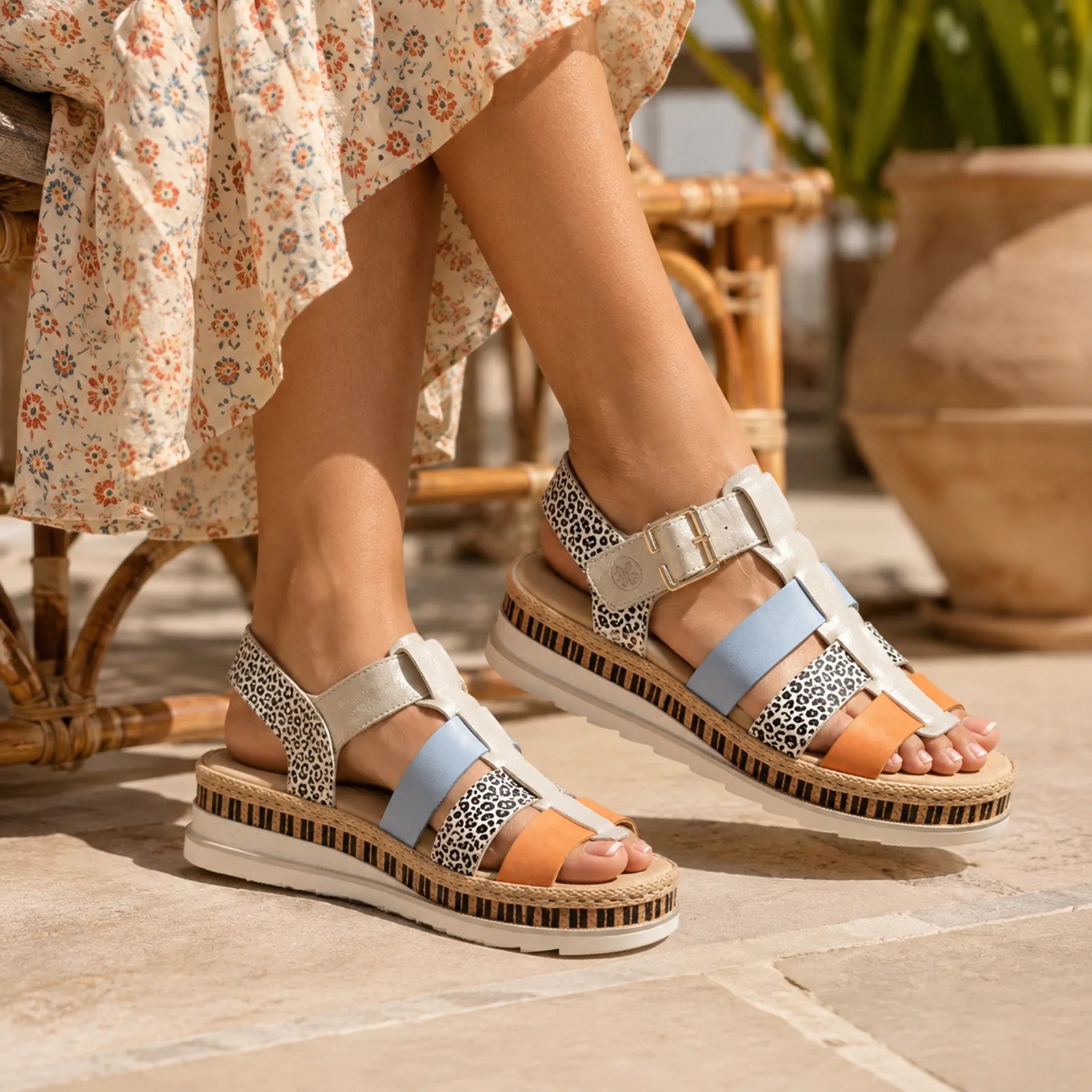 Women’s multi-strap platform sandals with leopard-print pattern, blue straps, orange accent