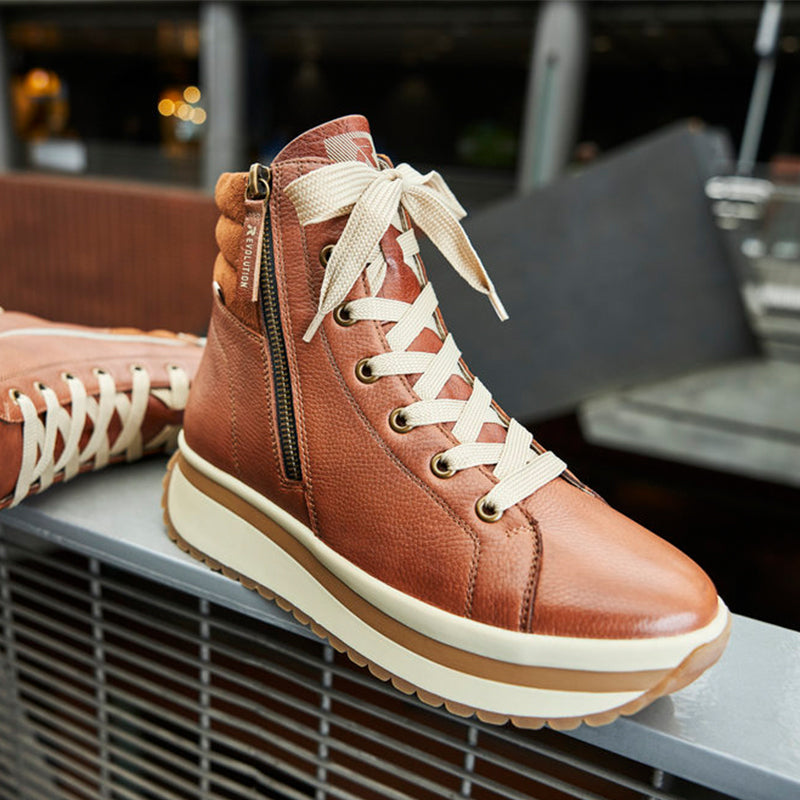 Brown winter boot with lace-up front, side zipper, and white midsole stripe