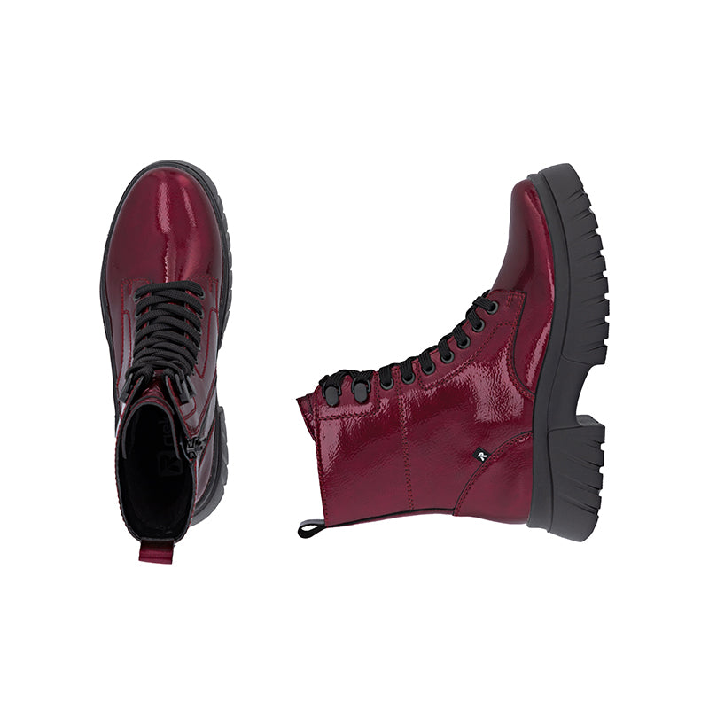 Dark red glossy leather lace-up ankle boots with black tread sole and heel tab