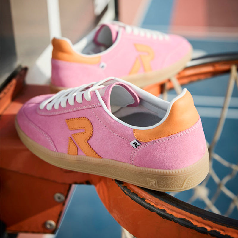 Pink leather lace-up sneaker with multicolor logo, white laces, gum sole.