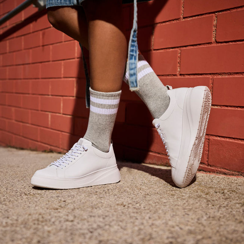 Rieker women's white lace-up sneakers worn with crew socks