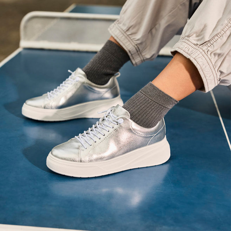 Rieker women's metallic silver lace-up sneakers worn with crew socks