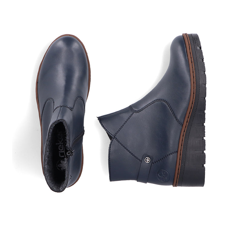 Women’s blue ankle boots close-up with side seam and brown-trim lug sole