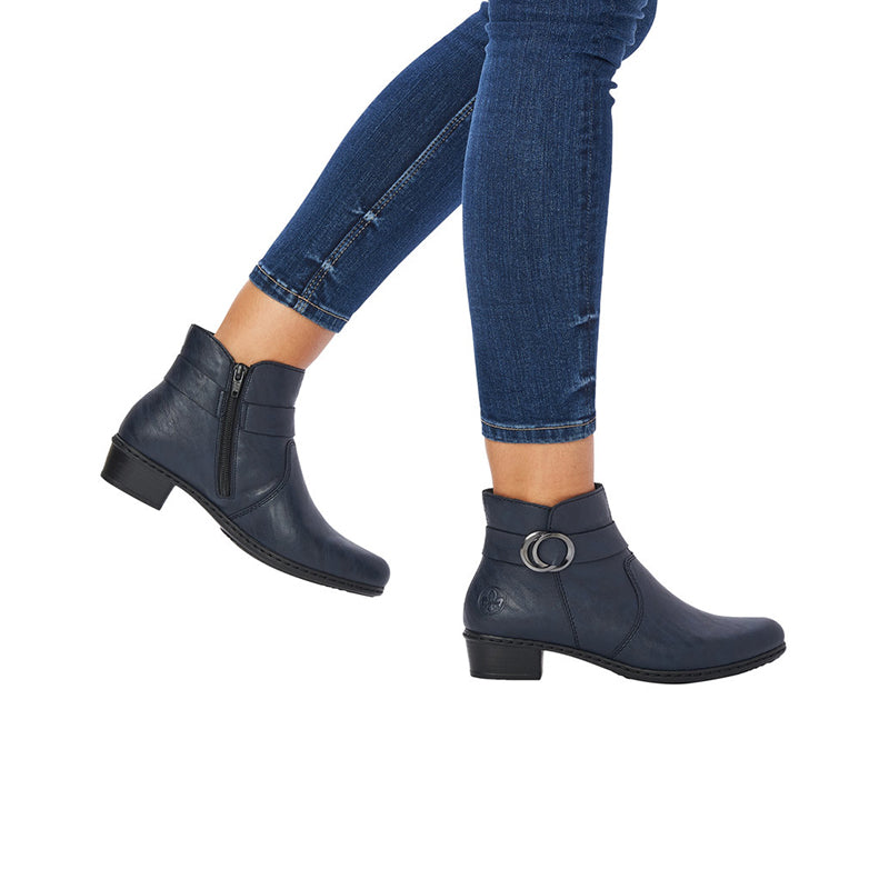 Blue ankle boots with side zipper and low block heel worn with jeans