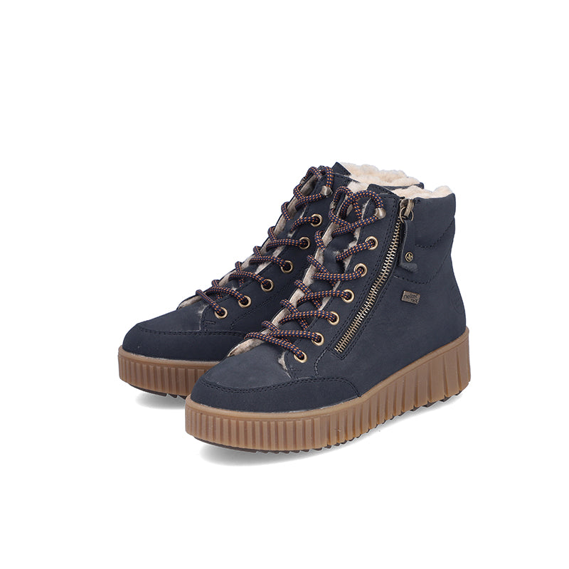 Blue ankle boots with lace-up front and side zip, padded collar, and chunky tan sole