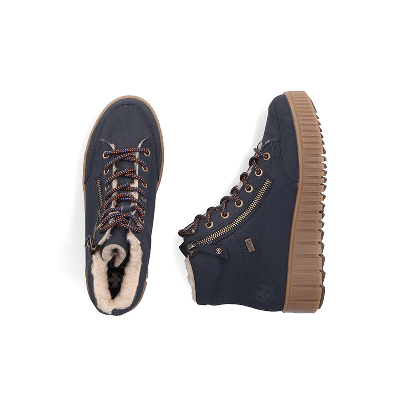 Blue ankle boots with lace-up front, side zipper, tan lug sole, and plush inner lining
