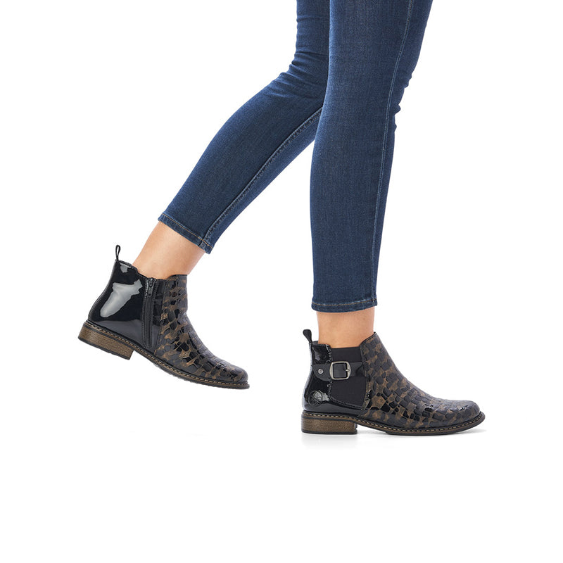 Rieker black ankle boots with side zip and patterned uppers, worn with blue jeans