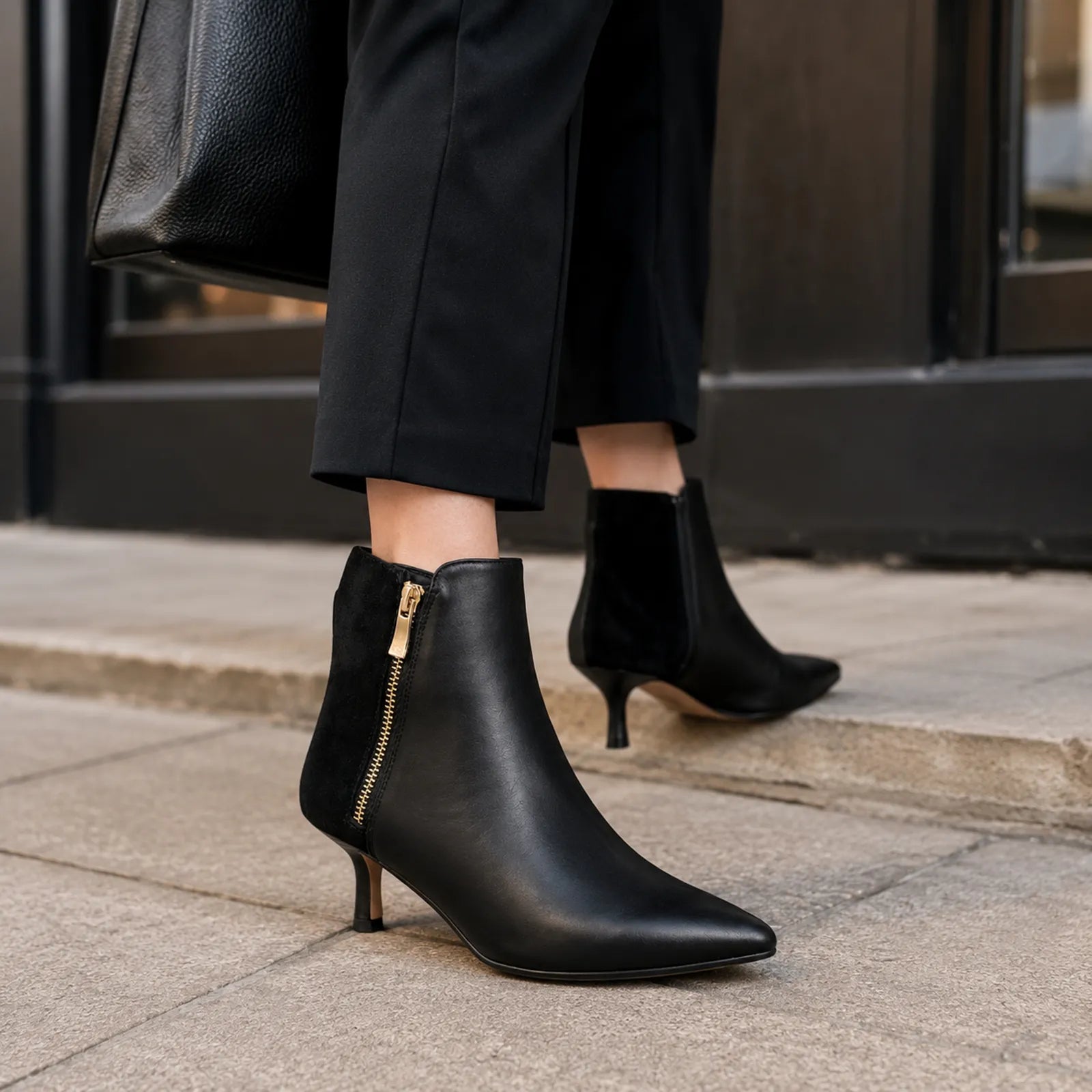 Black side-zip ankle boots with stiletto heel, worn with cropped pants